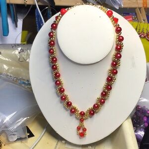 necklace- red faux pearls, 3 red bicones, 2 bright red round beads, gold beads.